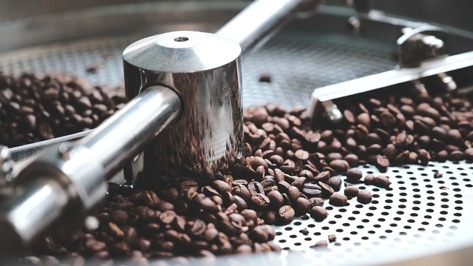 Freshly roasted beans turning in a roaster's cooling tray